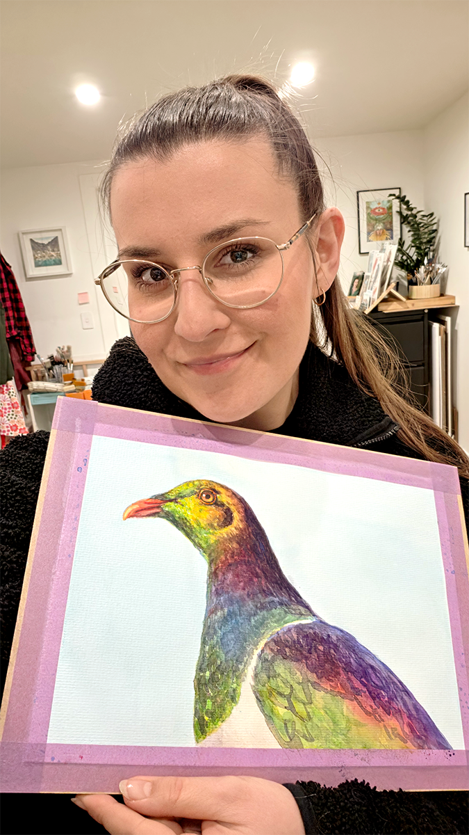 Kasia Hebda holding her kererū watercolour