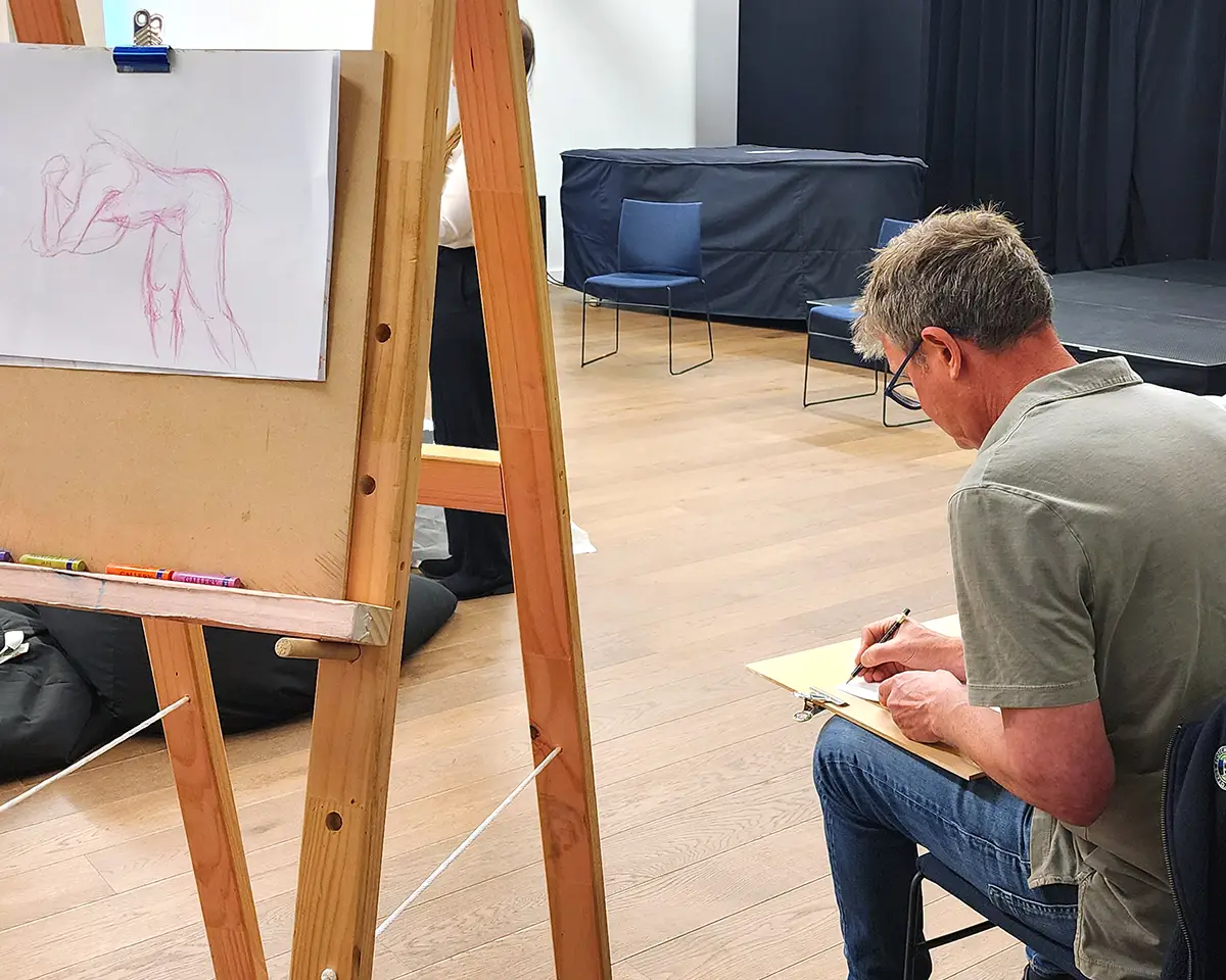 Students drawing from the model at a QAS life drawing class