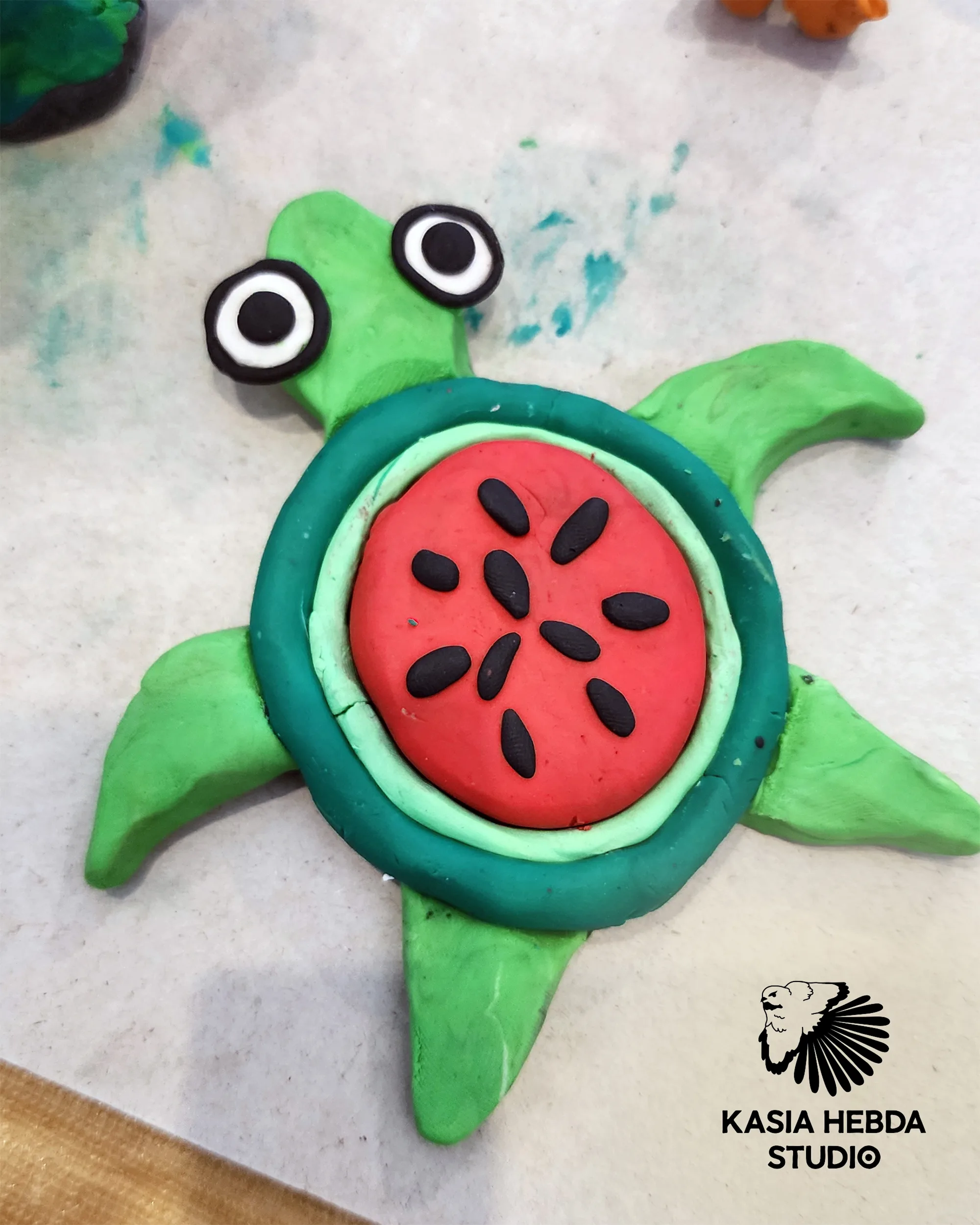 A clay turtle with a watermelon-patterned shell, made by a student