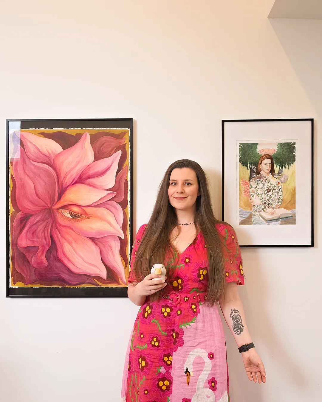 Kasia Hebda in her Queenstown studio, standing between two of her paintings