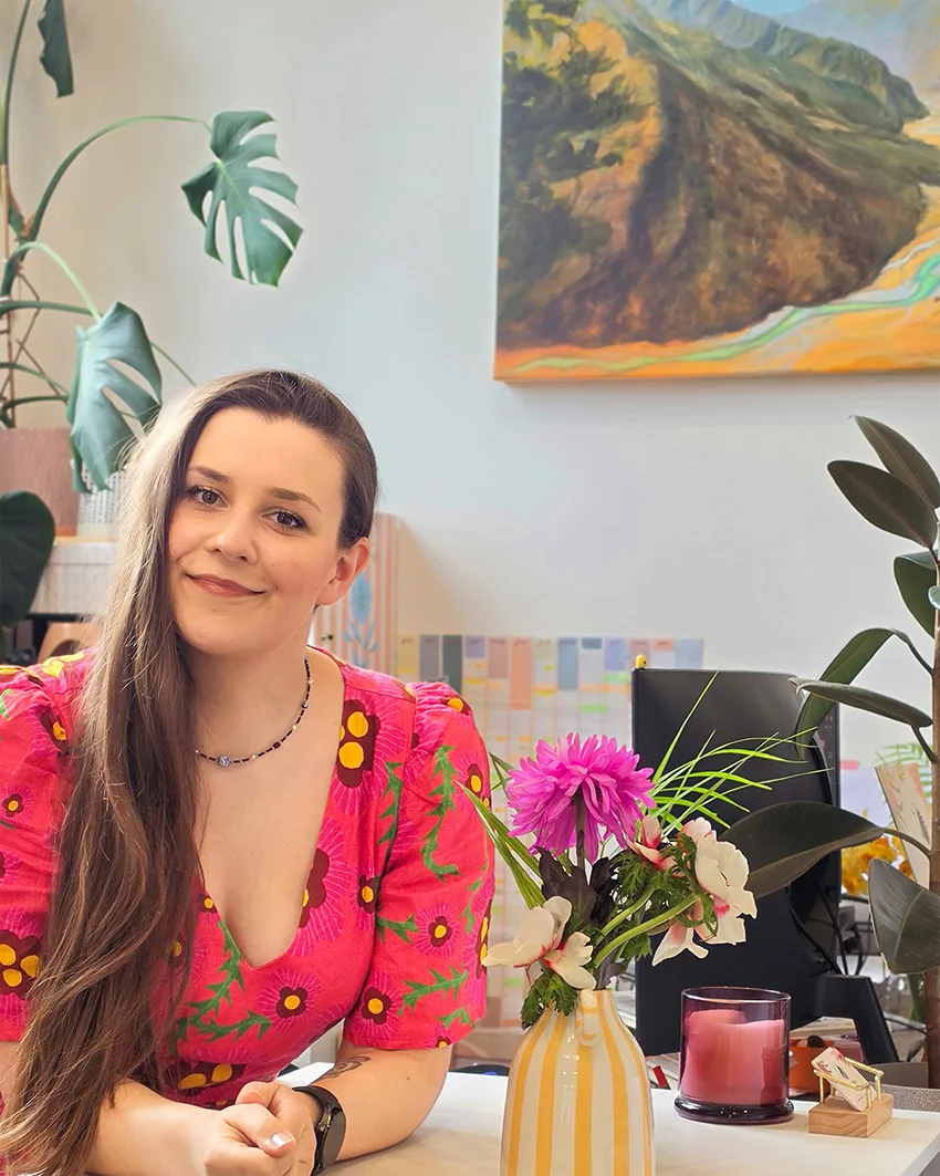Kasia Hebda in her watercolour studio in Frankton, Queenstown, with plants, flowers and her paintings