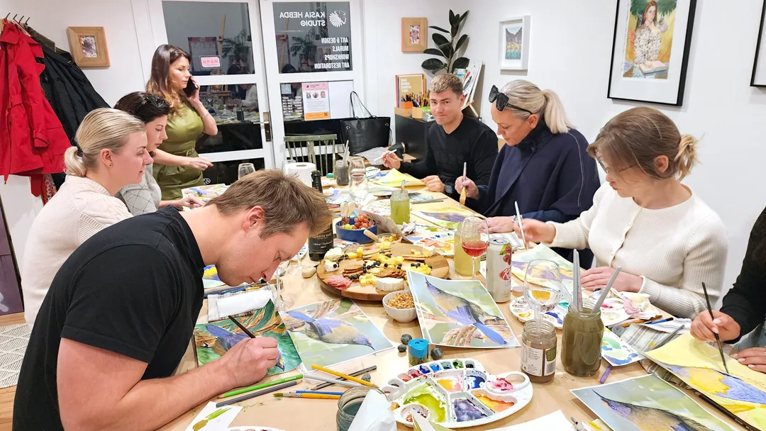 A private group painting together around the table at Kasia Hebda Studio, Queenstown